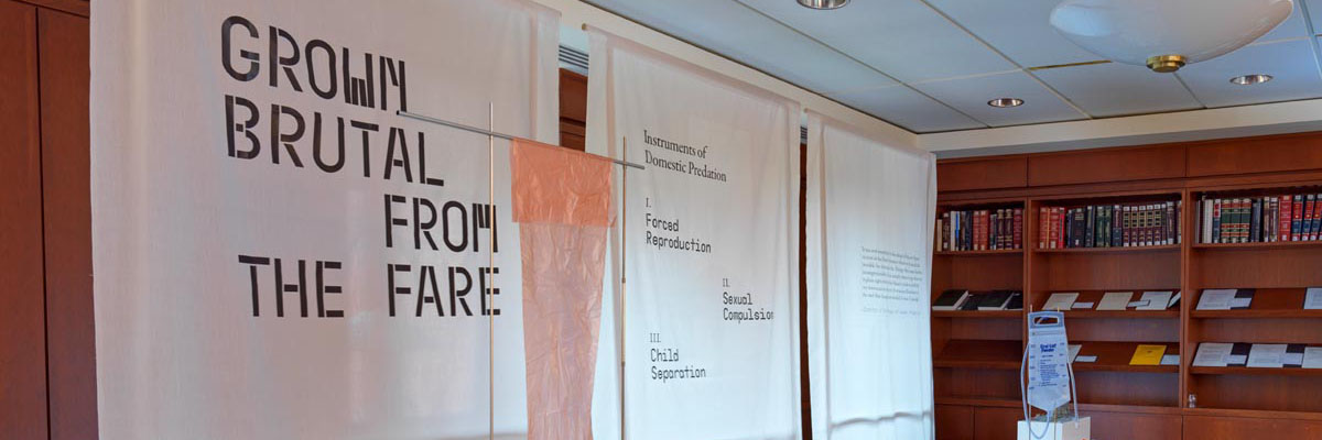 Animal production tools displayed on pedestal with banners behind them