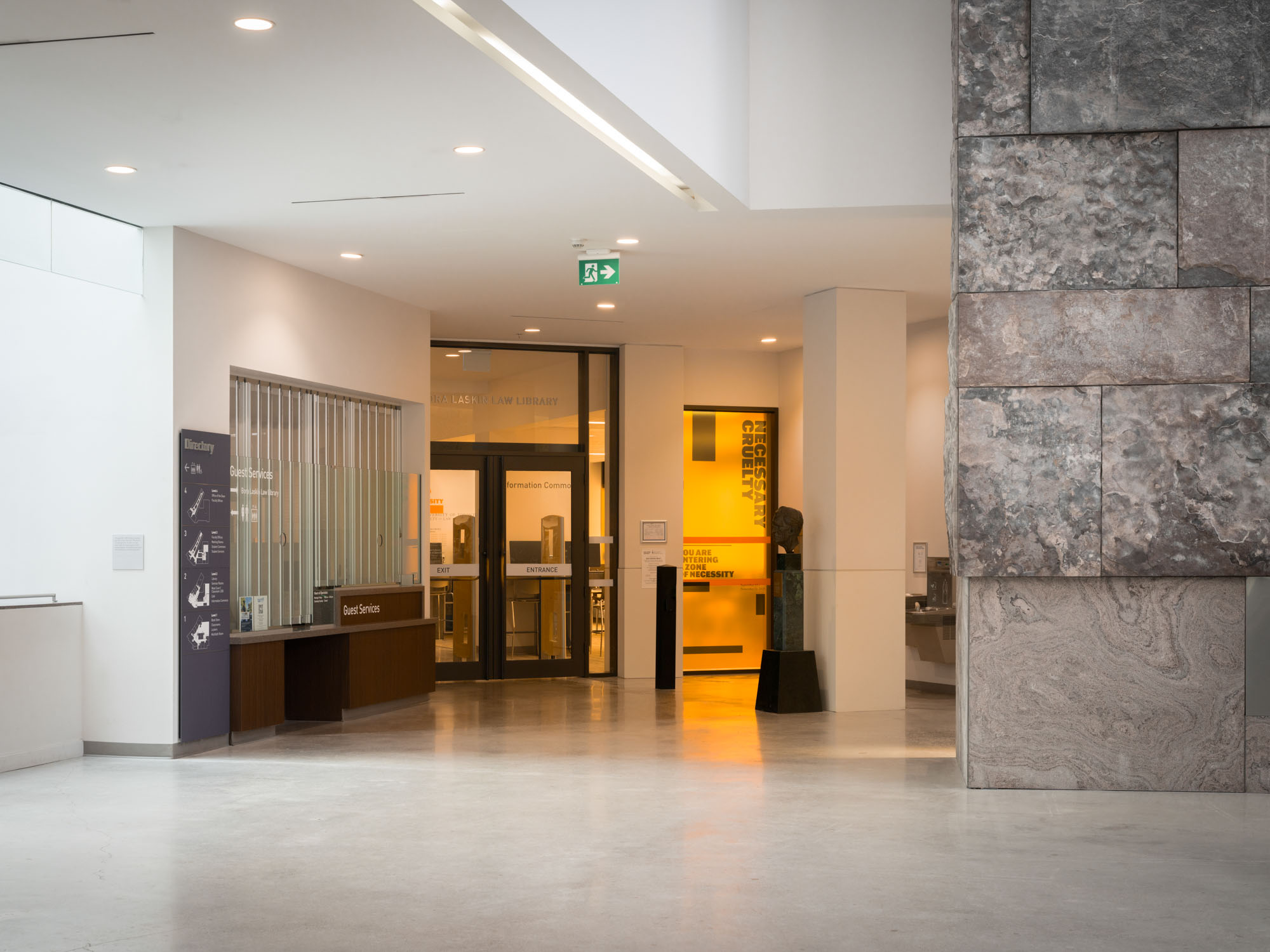 Entrance to the Bora Laskin law Library at the University of Toronto with Necessary Cruelty exhibition window vinyl signage